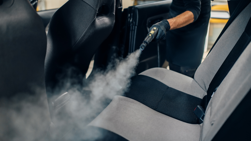 Steam cleaning the interior of a car, focusing on deep cleaning and sanitizing seats and surfaces