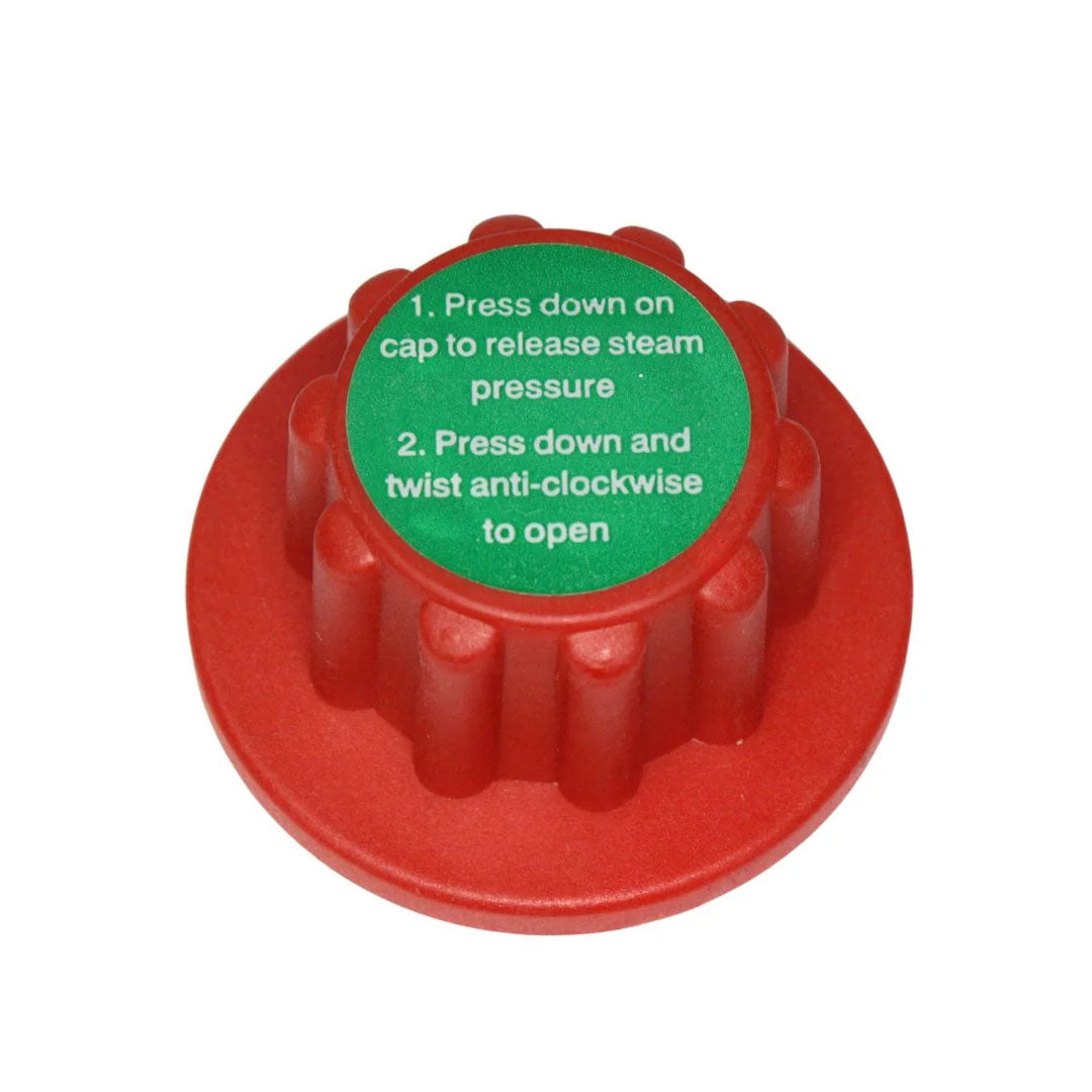 Top view of Aqua Pro Steamer locking pressure cap with green safety instructions for steam pressure release.