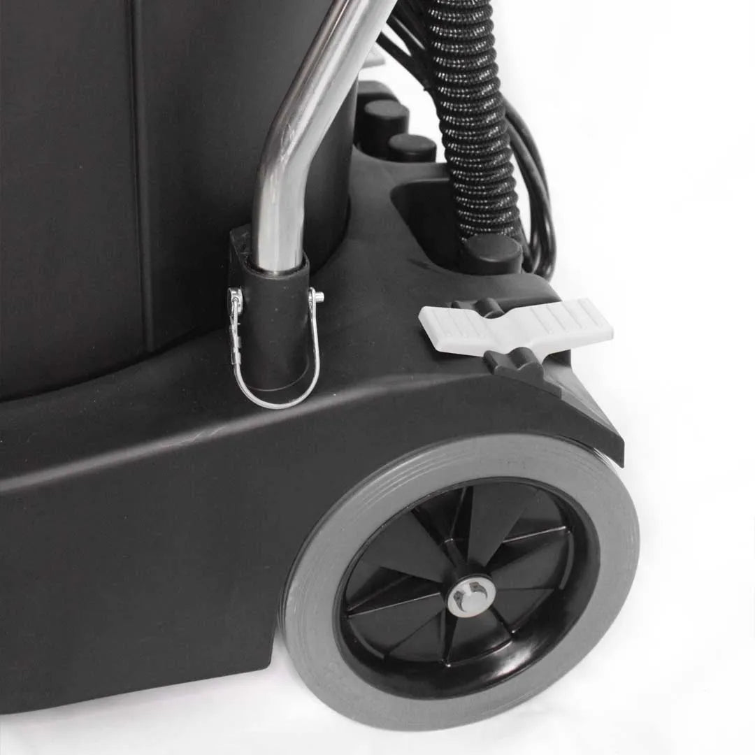 Detail view of Maxx Pro Vac base showing heavy-duty rear wheel, metal handle clip, and foot pedal