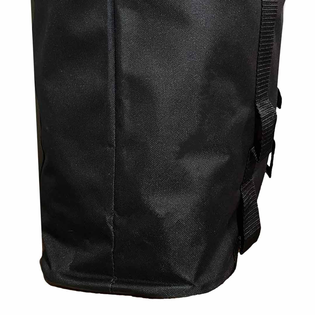 Side profile of the black accessory bag highlighting its vertical seam and tightly woven fabric.