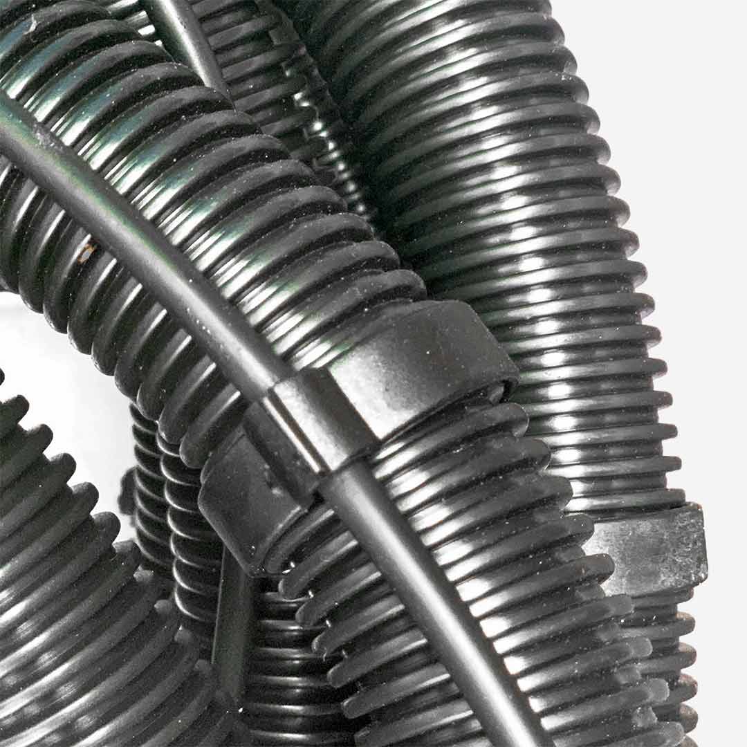 Detailed view showing Aqua Pro Vac's black clip tightly securing the water hose to the vacuum hose.