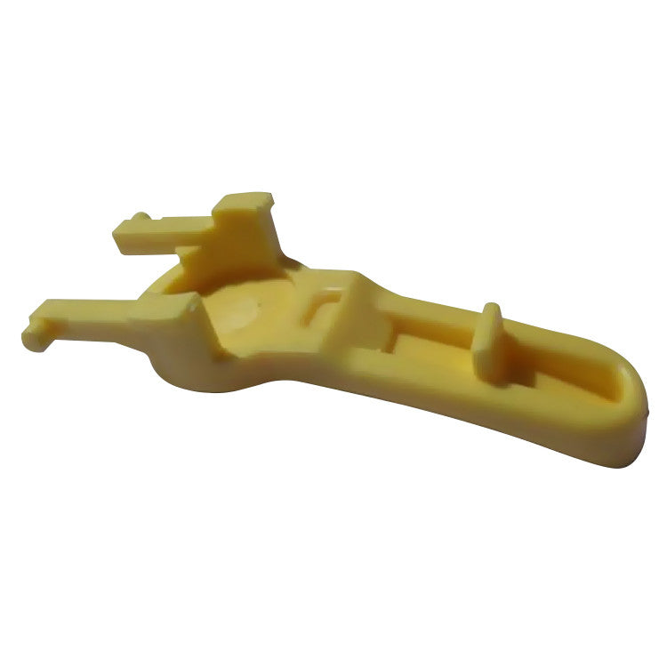 Bottom view of yellow replacement trigger button with attachment clips and internal grooves.