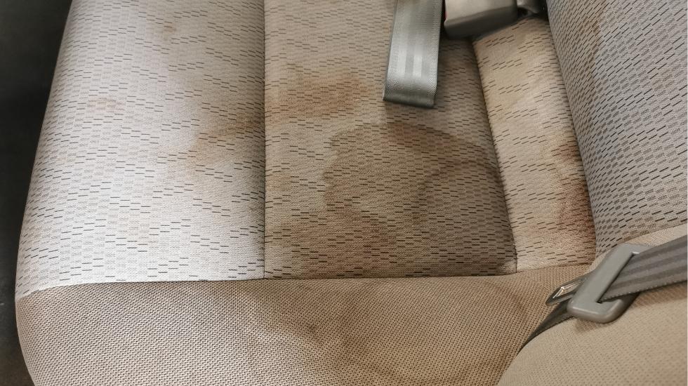Dirty car seat with visible stains, highlighting the need for deep cleaning and stain removal solutions