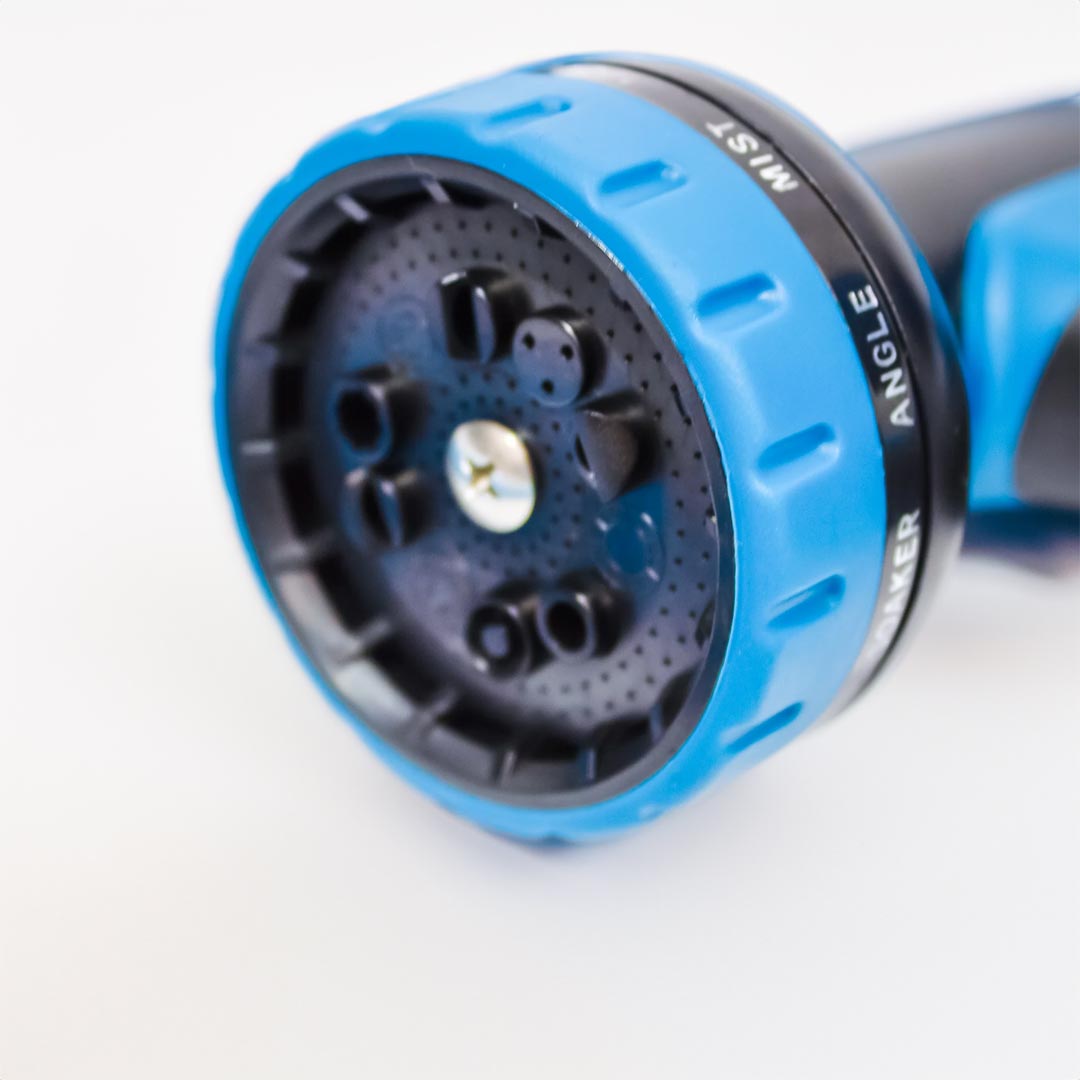 Close-up of the nozzle on an adjustable spray gun with a settings dial for multiple spray patterns, including mist and jet angles.