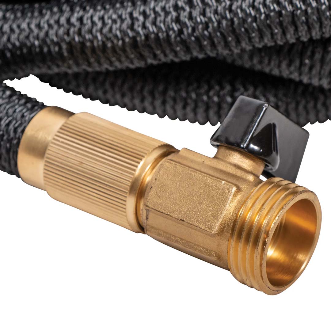 Close-up of the black woven expandable garden hose featuring a brass fitting with an attached black shut-off valve.