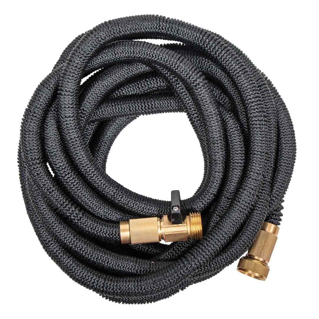 Coiled expanding water hose with a thick black woven casing, brass fittings, and a shut-off valve.